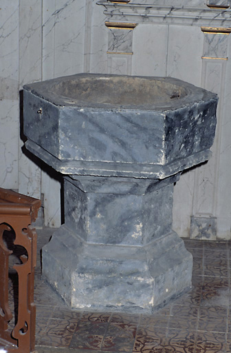 Vue d'ensemble des fonts baptismaux, en calcaire, datant du 15e siècle.