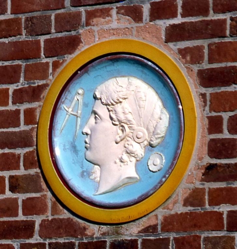 Détail d'un des deux médaillons de céramique signé Emile Muller (symbole de l'architecture), à droite de la façade sur rue.