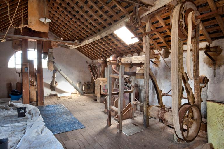 Vue intérieure de la minoterie, étage de comble, treuil monte-sac (au premier plan à droite).