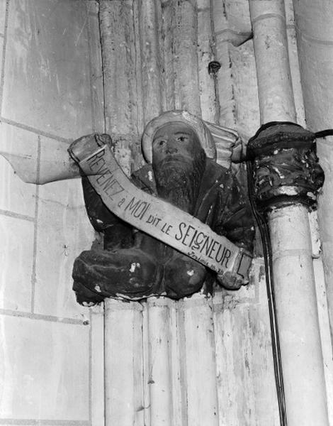 Transept sud, chapelle ouest, culot figuré représentant un personnage barbu portant un phylactère avec un texte de Jérémie : REVENEZ à MOI DIT LE SEIGNEUR.