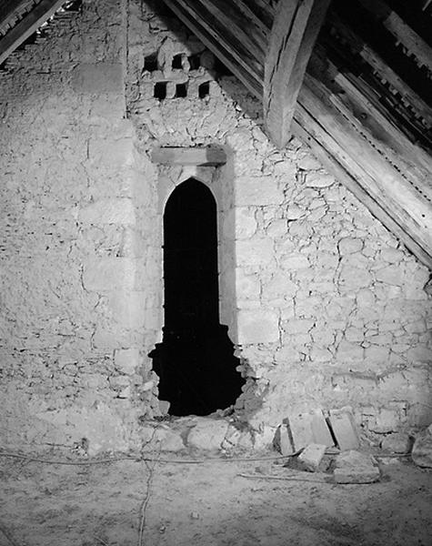 Vue intérieure du comble. Face interne d'une porte en arc brisé de l'édifice médiéval.