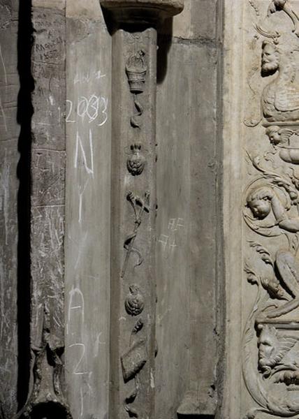 Contrefort de jonction entre la cinquième et la sixième travées sud : décor d'une colonnette engagée composé d'une chute d'objets suspendus à un fil (un seau à eau bénite, un bouquet de fleurs, une croix, un second bouquet et un livre).