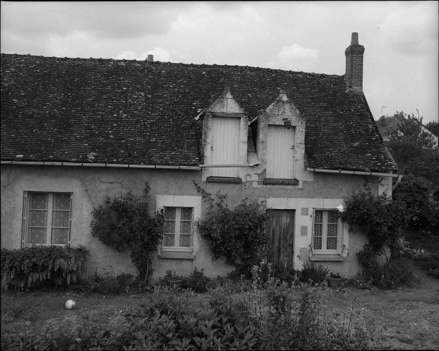 Rue des Ecoliers. Maison du bourg, façade sur rue avec deux lucarnes pendantes rapprochées.