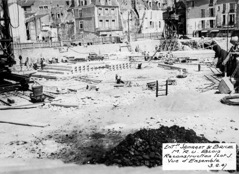 Vue du chantier de construction de l'îlot d'Etat J, au second plan, les pieux frettés en attente, 3-06-1947. (Archives départementales de Loir-et-Cher, Blois, 1195 W 44). ; Vue d'ensemble prise depuis le sud, au second plan, les pieux frettés en attente, 3-06-1947. (Archives départementales de Loir-et-Cher, Blois, 1195 W 44).