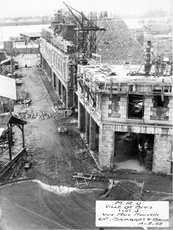 Construction du deuxième étage en cours, 02-1948. (Archives départementales de Loir-et-Cher, Blois, 1195 W 44). ; Rue Henry-Drussy, construction des 2e niveau au-dessus du rez-de-chaussée : 2e étage carré pour l'immeuble du premier plan, étage de comble pour les autres, 4-02-1948. (Archives départementales de Loir-et-Cher, Blois, 1195 W 44).