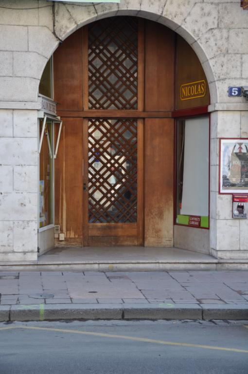 Exemple de porte au fond d'un porche dans oeuvre ouvert sur des vitrines, 5 rue Denis-Papin.