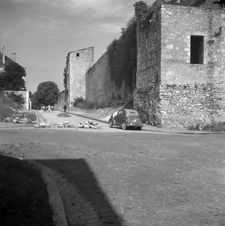 Vue de la rue Trouessard avant la démolition du mur des remparts et de la tour et la construction de l'école maternelle, autour de 1950. (Archives Départementales de Loir-et-Cher, Blois, Fonds Lunais-Bruère, 105 Fi 1373). ; Vue de la rue Trouessard avant la démolition du mur des remparts et de la tour et la construction de l'école maternelle, autour de 1950. (Archives Départementales de Loir-et-Cher, Blois, Fonds Lunais-Bruère, 105 Fi 1373).