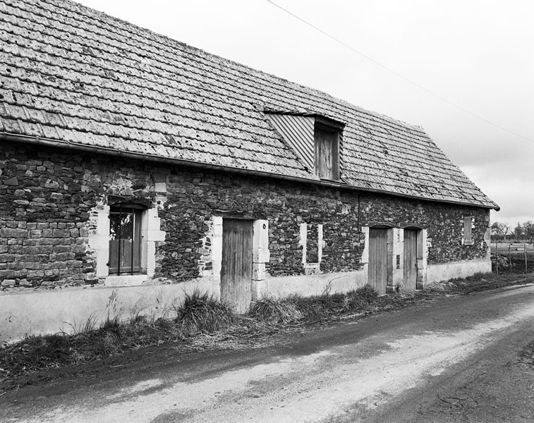 Le Champ Sommier. Maison de journalier n°1. Elévation extérieure sud. ; Maison de journalier n°1. Elévation extérieure sud. Appareil mixte de plaquettes de schiste et encadrement de baies calcaire.