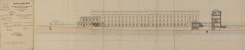 Elévation de la façade est et d'un pavillon de malades et de la chapelle. Dressé conformément à la décision ministérielle du 19 décembre 1863 par Pasquier-Vauvilliers. Approuvé le 21 mars 1865 par le ministre de la Marine, le comte de Chasseloup-Laubat.- Dessin à l'encre sur papier. (Ministère de la Défense, service historique de la Marine, Cherbourg-Octeville. 3K 60).
