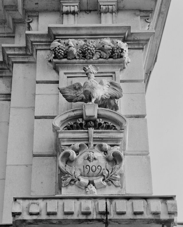 Façade : détail du décor du pilastre gauche et de la date 1909 gravée dans le cartouche