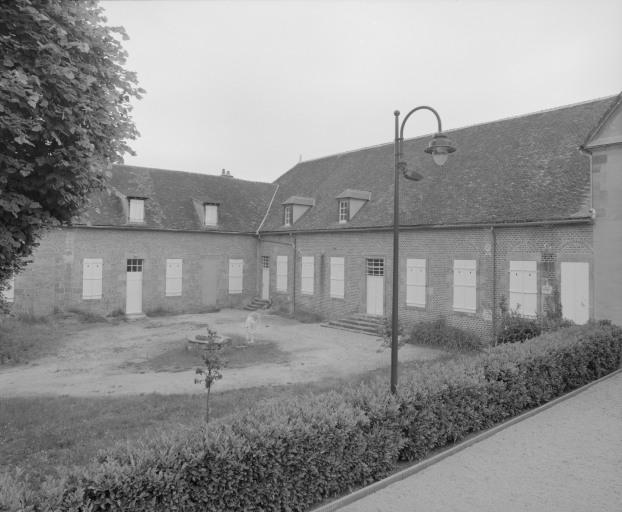 Vue d'ensemble du bâtiment : ancienne salle des malades et cour.
