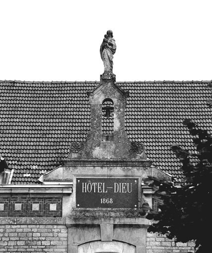 Façade antérieure, détail du fronton avec cloche et statue.