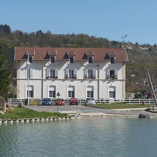 L'ancienne gare de Plombières-lès-Dijon transformée en logement, vue de face, avec le bassin du port au premier plan.