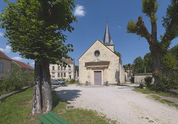 L'église de Gissey de face, la mairie-école à gauche et à droite, le cimetière, derrière dans les arbres, le château.