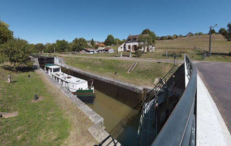 Le site d'écluse avec passage d'un bateau.
