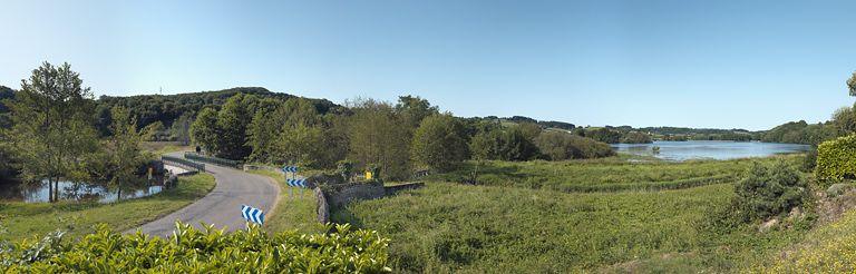 Vue du bassin de compensation de Pannecière avec au premier plan l'ancienne prise d'eau de la rigole d'Yonne et au fond, le barrage avec la nouvelle prise d'eau.