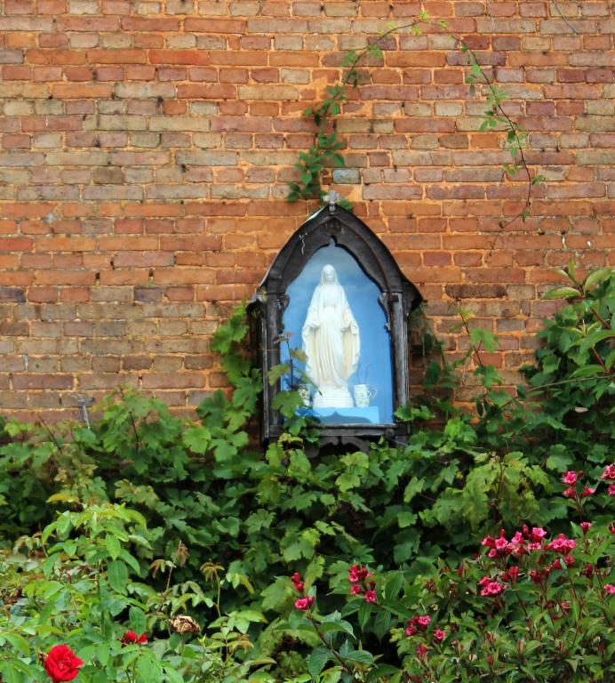 Mariette installée dans une vitrine sur le pignon d'une maison.- Route de Routot. 