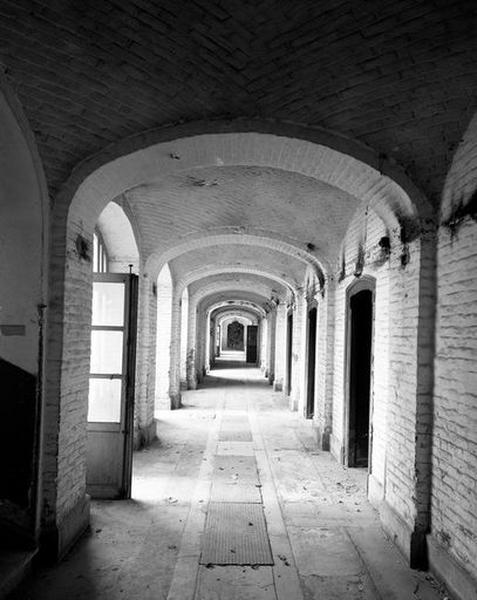 Galerie voûtée située en bordure de la cour des services généraux, au niveau de l'étage de soubassement, section ouest, vue en enfilade.