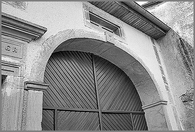 Ferme, élévation antérieure, porte charretière, détail : décor de clé sur agrafe, ensemble trois quarts gauche.