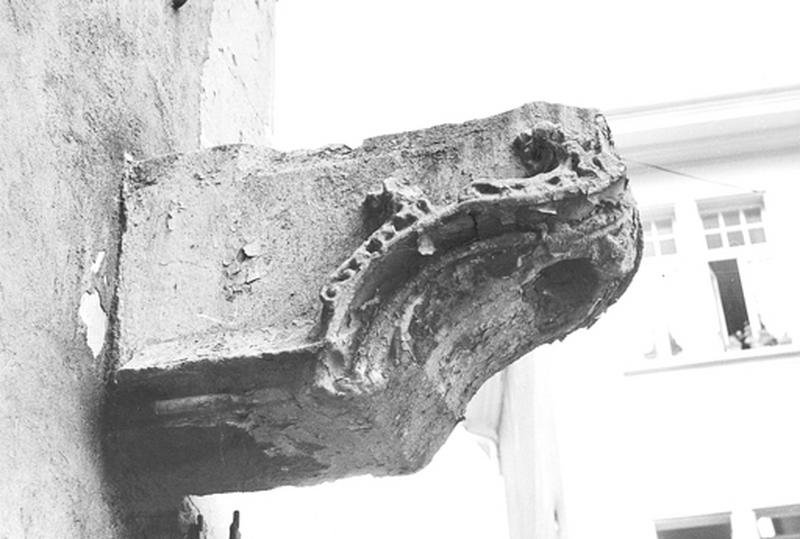 Potence du puits disparu encastrée dans le mur.