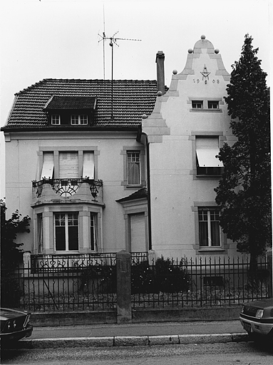 Vue de l'emblème de maçon ou d'architecte sur la façade d'une villa, 140 rue de Belfort.
