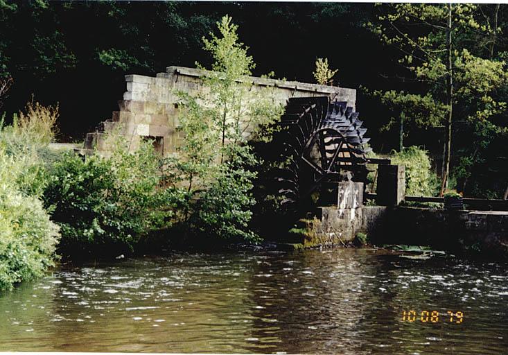 Vue des vestiges du moulin avec roue sur la rive droite.