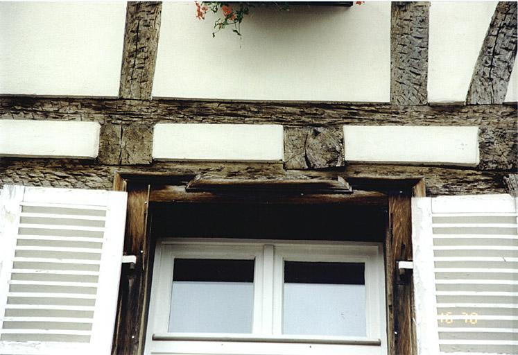 Détail d'une fenêtre avec chambranle à crossettes, au 1er étage, côté rue.