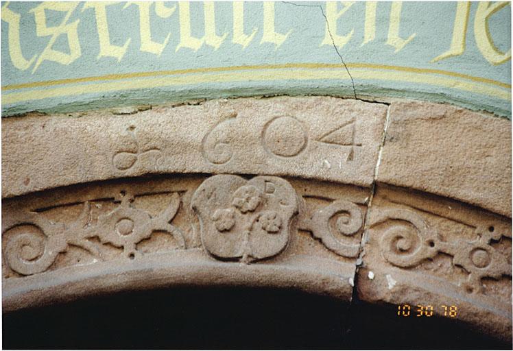 Porte de l'ancien passage d'entrée. Vue partielle avec écu et date.