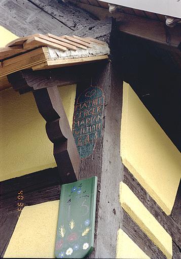 Vue du poteau cornier et de l'inscription de la ferme, No 13, rue Principale.