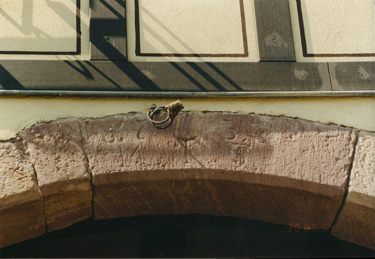 Détail du claveau central de la porte cochère du logis, située gouttereau sur rue, daté de 1732.