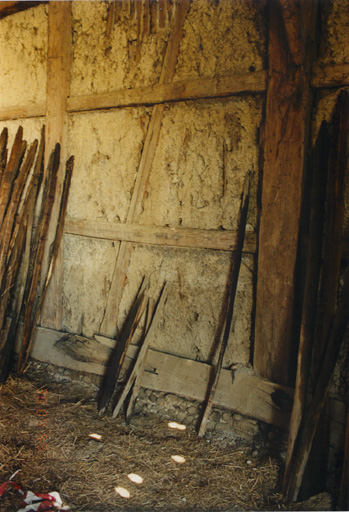 Pignon intérieur nord de la grange-étable, avec sablière basse sur soubassement en galets. Vue de détail.
