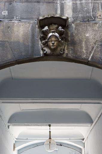 Première cour : détail du plafond du passage cocher avec une figure casquée sur la clé d'un arc.