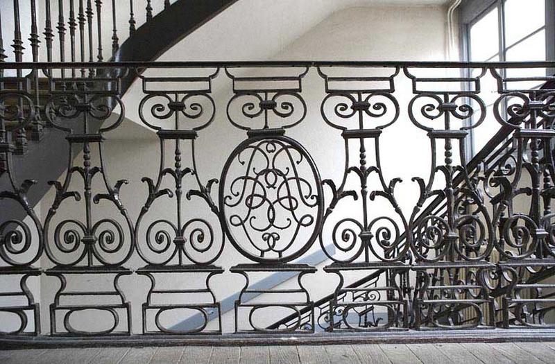 Détail des motifs en fer forgé de la rampe d'escalier.