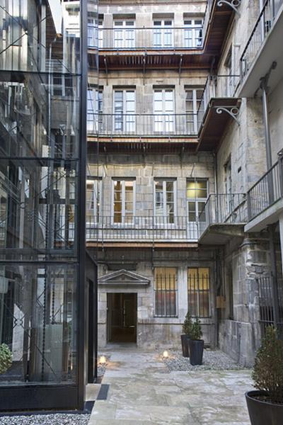 Vue d'ensemble des façades de l'hôtel depuis le fond de la cour.