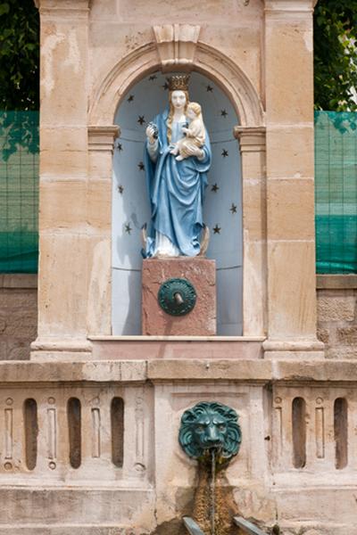 Niche centrale de la borne fontaine abritant une statue de la Vierge à l'Enfant.