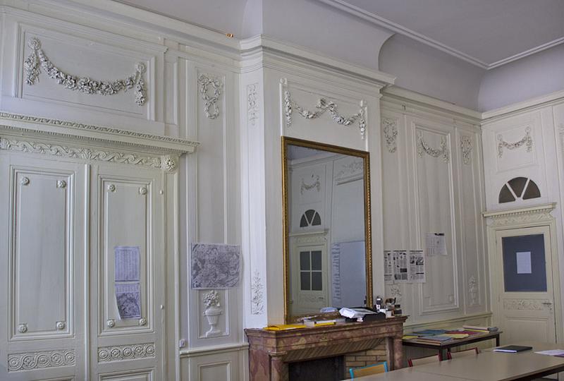 Intérieur, chambre à gauche du salon : lambris et cheminée, vue rapprochée.