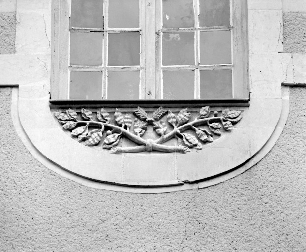 Relief avec les flèches entrecroisées sur une allège de fenêtre, sur l'aile orientale du cloître.