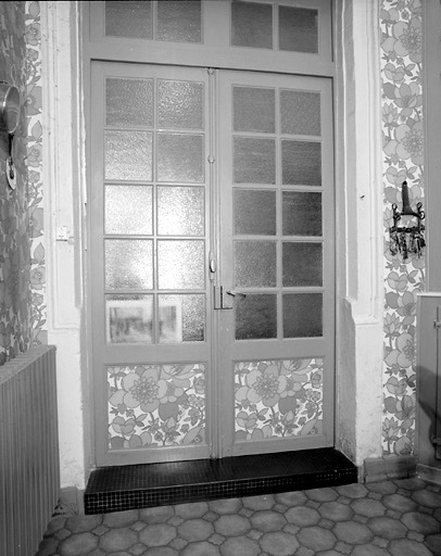 Vue prise de l'intérieur de la cour, récemment aménagée en salle à manger, montrant la mouluration d'une fenêtre d'origine du bâtiment sur rue.