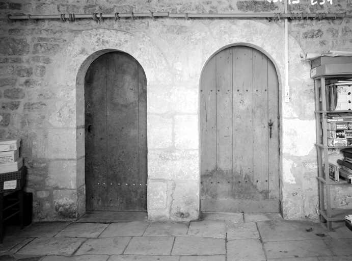 Logis, rez de chaussée, pièce centrale, portes d'un réduit et de l'accès à l'escalier.