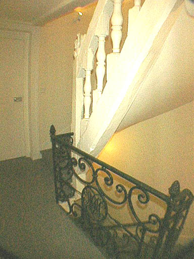 Escalier, premier étage, passage de la rampe en ferronnerie à la rampe en bois.