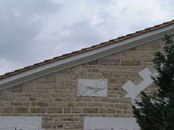 Logis, élévation antérieure, vue prise du sud, détail de la plaque sculptée d'une main tenant un miroir, symbole du faux.