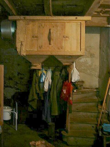 Moulin, intérieur, rez-de-chaussée, partie de la bluterie et escalier tournant en bois donnant accès à l'étage.