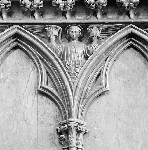 Dorsal des stalles disposées à gauche dans le choeur, détail de l'écoinçon placé entre les stalles 14 et 15 : ange tenant des couronnes.