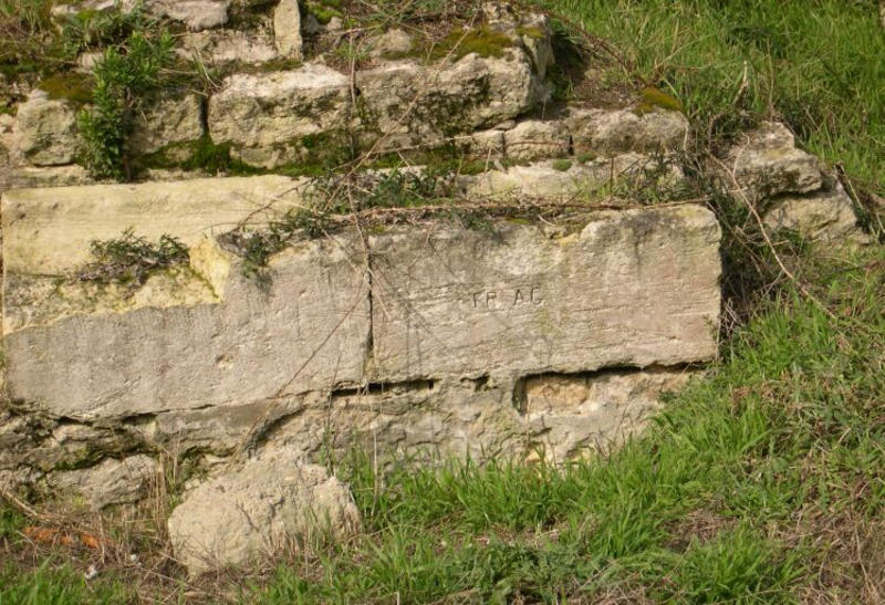 Massif en maçonnerie à l'ouest du logement au sud, détail avec inscription : FRAG