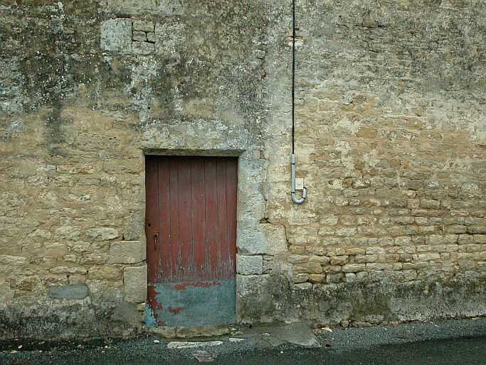 Porte chanfreinée ouvrant sur la rue de l'Ecole.