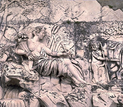 Une femme symbolisant la Garonne tient une corne d'abondance et regardedans la direction d'un génie travaillant la terre.