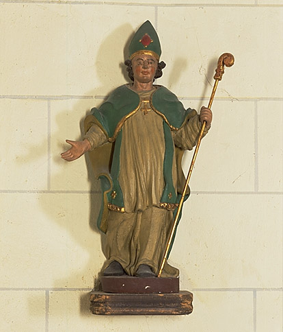 Saint évêque à gauche du tabernacle.