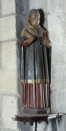 Vue générale de face : saint Côme (ou saint Damien), tenant une spatule de la main droite et une boîte à onguents en forme de tourelle dans la main gauche.