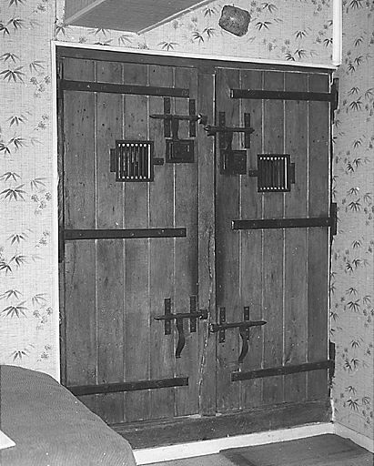 Intérieur, rez-de-chaussée. Porte fermant les deux anciens cachots.