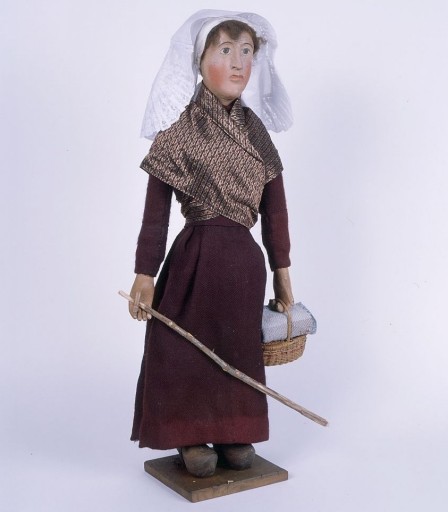 Paysanne portant un panier en osier à couvercle : vue de face latérale gauche après restauration.